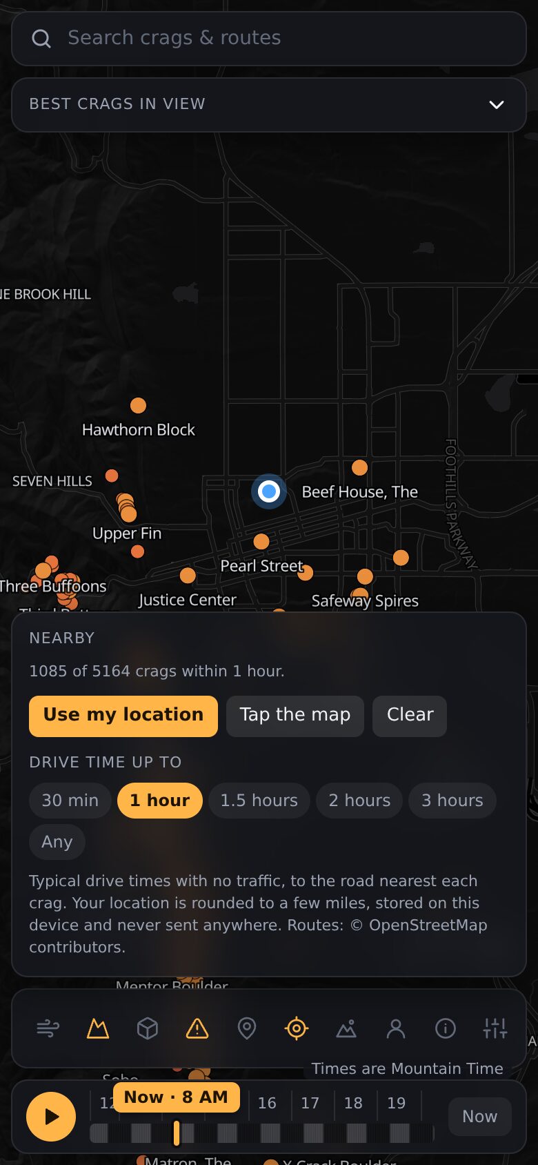 On a phone, the Nearby panel limiting the map to crags within one hour's drive.